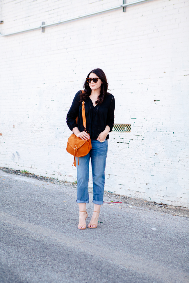 Black eyelet top paired with boyfriend jeans on Kendi Everyday