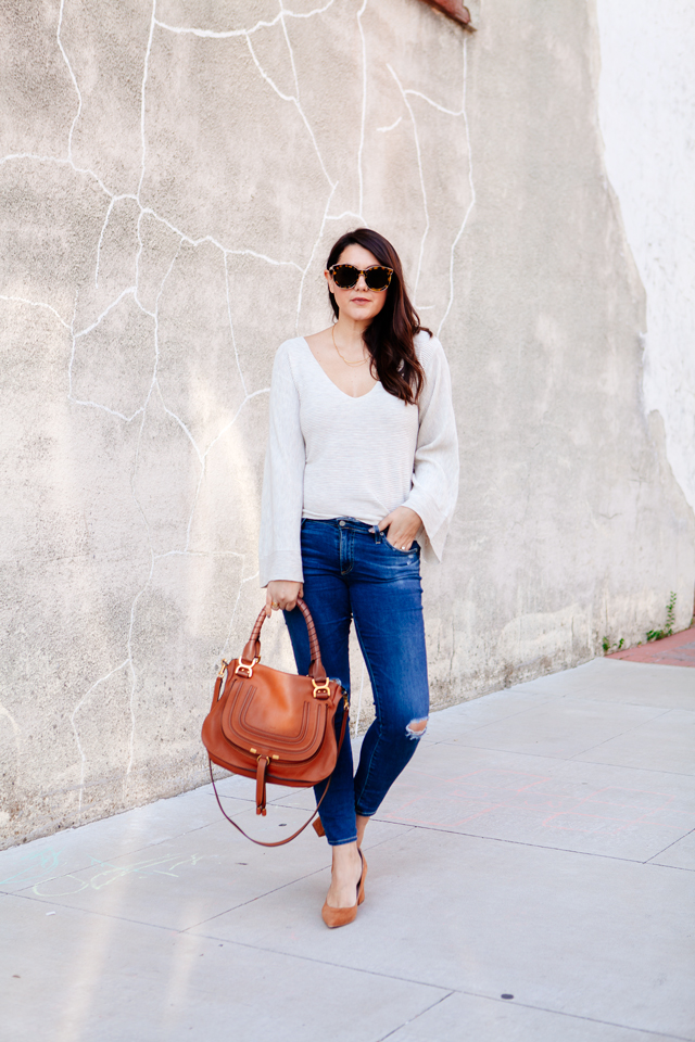 Bell sleeve sweater with skinny jeans and cognac accessories. 